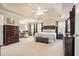 Luxurious main bedroom with tray ceilings, large windows, and sitting area at 586 Devon Brooke Dr, Woodstock, GA 30188