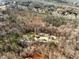 Aerial shot of a wooded property featuring a home with a pool at 6734 Pass Road, Buford, GA 30518