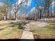 Picturesque backyard with mature trees and a stone pathway at 6734 Pass Road, Buford, GA 30518