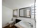 Bathroom with a toilet, sink with counter, and a dark-framed mirror at 6734 Pass Road, Buford, GA 30518