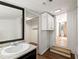 Well-lit bathroom featuring a sink with a dark vanity and a walk-in closet at 6734 Pass Road, Buford, GA 30518