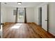 Bright bedroom featuring wood-look floors, and a window with natural light at 6734 Pass Road, Buford, GA 30518