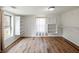 Bright bedroom with laminate floors, built-in shelves, and a window at 6734 Pass Road, Buford, GA 30518