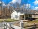 A well-maintained home featuring white siding, a covered patio, and fenced backyard at 6734 Pass Road, Buford, GA 30518