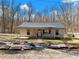 Cozy home with a covered front porch and decorative rock landscaping at 6734 Pass Road, Buford, GA 30518