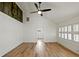 Modern living room features wood-look flooring, shiplap walls, and a ceiling fan at 6734 Pass Road, Buford, GA 30518