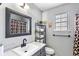 Well-lit bathroom with a modern vanity, black fixtures, and a decorative mirror at 2583 Bronco Trl, Duluth, GA 30096