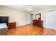 Bedroom featuring hardwood floors, a ceiling fan, and ample space for furniture at 2583 Bronco Trl, Duluth, GA 30096