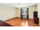 Bedroom featuring hardwood floors, a ceiling fan, and a large window for ample natural light at 2583 Bronco Trl, Duluth, GA 30096