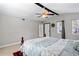 Bright bedroom features a ceiling fan, natural light from windows, and access to an exterior door at 2583 Bronco Trl, Duluth, GA 30096