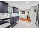 Well-designed kitchen features stainless appliances, gray cabinets, and a view into the dining room at 2583 Bronco Trl, Duluth, GA 30096