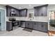 Newly renovated kitchen with stainless steel appliances, sleek gray cabinets, and subway tile backsplash at 2583 Bronco Trl, Duluth, GA 30096