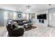 Cozy living room featuring a large sectional sofa, tile floors, and a decorative fireplace at 2583 Bronco Trl, Duluth, GA 30096