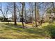 Backyard features a creek, mature trees, and a blue home at 2858 Skyland Ne Dr, Brookhaven, GA 30341