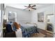 Bright bedroom featuring hardwood floors, a decorative ceiling fan, and a comfortable antique-style brass bed frame at 2858 Skyland Ne Dr, Brookhaven, GA 30341