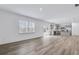 Spacious living room showcasing hardwood floors, natural light, and an open floor plan flowing to the kitchen at 3204 Birdsong Ave, Covington, GA 30016