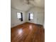 Bedroom boasts wood floors and natural light from two windows at 4622 Dogwood Rd, Pine Lake, GA 30083