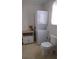 Compact laundry area with stacked washer/dryer and toilet at 4622 Dogwood Rd, Pine Lake, GA 30083