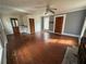 Bright living room featuring wood floors, a ceiling fan, and paneled walls at 4622 Dogwood Rd, Pine Lake, GA 30083