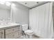 Bathroom with a marble vanity, sink, toilet, and shower with a white curtain at 795 Hammond Dr # 801, Atlanta, GA 30328