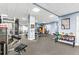 Community gym with stationary weight machines, free weights, and mounted TV at 795 Hammond Dr # 801, Atlanta, GA 30328