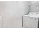 A laundry area features a white dryer and storage shelves, creating a practical and organized space at 795 Hammond Dr # 801, Atlanta, GA 30328