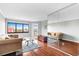 Bright living area featuring hardwood floors, a brown sofa, a glass-topped coffee table, and a wall of mirrors at 795 Hammond Dr # 801, Atlanta, GA 30328