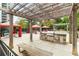 An outdoor grilling area featuring stainless steel appliances and stone countertops under a charming pergola at 795 Hammond Dr # 801, Atlanta, GA 30328