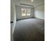 Well-lit bedroom with neutral carpet and two windows at 203 Groveton Ct, Euharlee, GA 30145