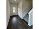 Entryway with wood floors, stairs and front door at 203 Groveton Ct, Euharlee, GA 30145