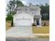 Charming two-story home featuring a two-car garage and manicured lawn at 203 Groveton Ct, Euharlee, GA 30145