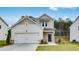 Charming two-story home with a two-car garage and a well-manicured front lawn at 203 Groveton Ct, Euharlee, GA 30145