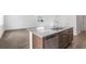 Modern kitchen island featuring a granite countertop, stainless steel dishwasher, and stylish wood cabinets at 203 Groveton Ct, Euharlee, GA 30145