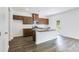 An open-concept kitchen with stainless steel appliances, a central island, and a modern design at 203 Groveton Ct, Euharlee, GA 30145
