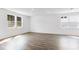 Bright and airy living room featuring large windows and hardwood floors at 203 Groveton Ct, Euharlee, GA 30145