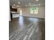 Bright living area with dark wood flooring and windows overlooking the yard at 203 Groveton Ct, Euharlee, GA 30145