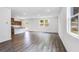 Open-concept living space with hardwood floors connecting the living area to the kitchen at 203 Groveton Ct, Euharlee, GA 30145