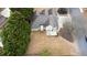 A high angle shot of the home showing the roof, lawn, and surrounding trees at 3402 Blaisdell Rd, Buford, GA 30519