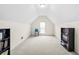 Attic bonus room with carpet, a window, and built in bookshelves at 3402 Blaisdell Rd, Buford, GA 30519