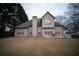 Back of house with large windows and a patio area for outdoor seating at 3402 Blaisdell Rd, Buford, GA 30519
