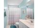Bright bathroom with a decorative shower curtain, and a vanity with a white countertop at 3402 Blaisdell Rd, Buford, GA 30519