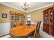Traditional dining room with elegant wood furniture, chandelier, and wainscoting at 3402 Blaisdell Rd, Buford, GA 30519