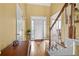 Bright foyer featuring hardwood floors, a staircase, and a view into other rooms of the home at 3402 Blaisdell Rd, Buford, GA 30519