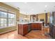 Open kitchen featuring wood floors, stainless steel dishwasher, and large window for natural lighting at 3402 Blaisdell Rd, Buford, GA 30519
