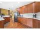 Kitchen with wood cabinets, stainless appliances and a view into other rooms at 3402 Blaisdell Rd, Buford, GA 30519