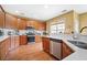 Well-lit kitchen boasts stainless steel appliances, modern cabinets, hard wood floors and white countertops at 3402 Blaisdell Rd, Buford, GA 30519