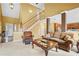 Bright and airy living room featuring a fireplace, staircase and open floor plan at 3402 Blaisdell Rd, Buford, GA 30519
