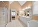 Spacious main bathroom features double vanity, soaking tub, and glass-enclosed shower at 3402 Blaisdell Rd, Buford, GA 30519