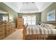 Spacious main bedroom featuring a tray ceiling, carpeted floors, and ample natural light at 3402 Blaisdell Rd, Buford, GA 30519