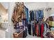 Spacious walk-in closet with ample hanging space, shelving, and a glimpse into an ensuite bathroom at 3402 Blaisdell Rd, Buford, GA 30519